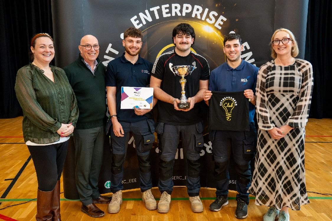 Katie Matthews-Furphy, The Mind Tribe UK, Irvine Abraham, Above Ground Level and (far right) Bronagh Ward, Royal Academy of Engineering with winners of the SERC PBL X 2026 Competition for their Security Engineering & Resource Centre project, Harry Johnston, Zeki Kaya (both Newtownards), and Fernando Gomes Da Silva (from Magherafelt).   